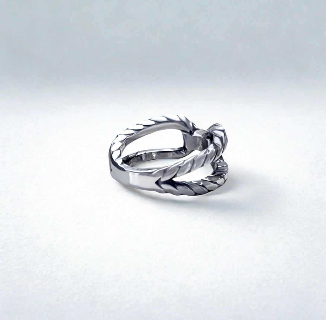 Silver ring with a textured design on a light gray background